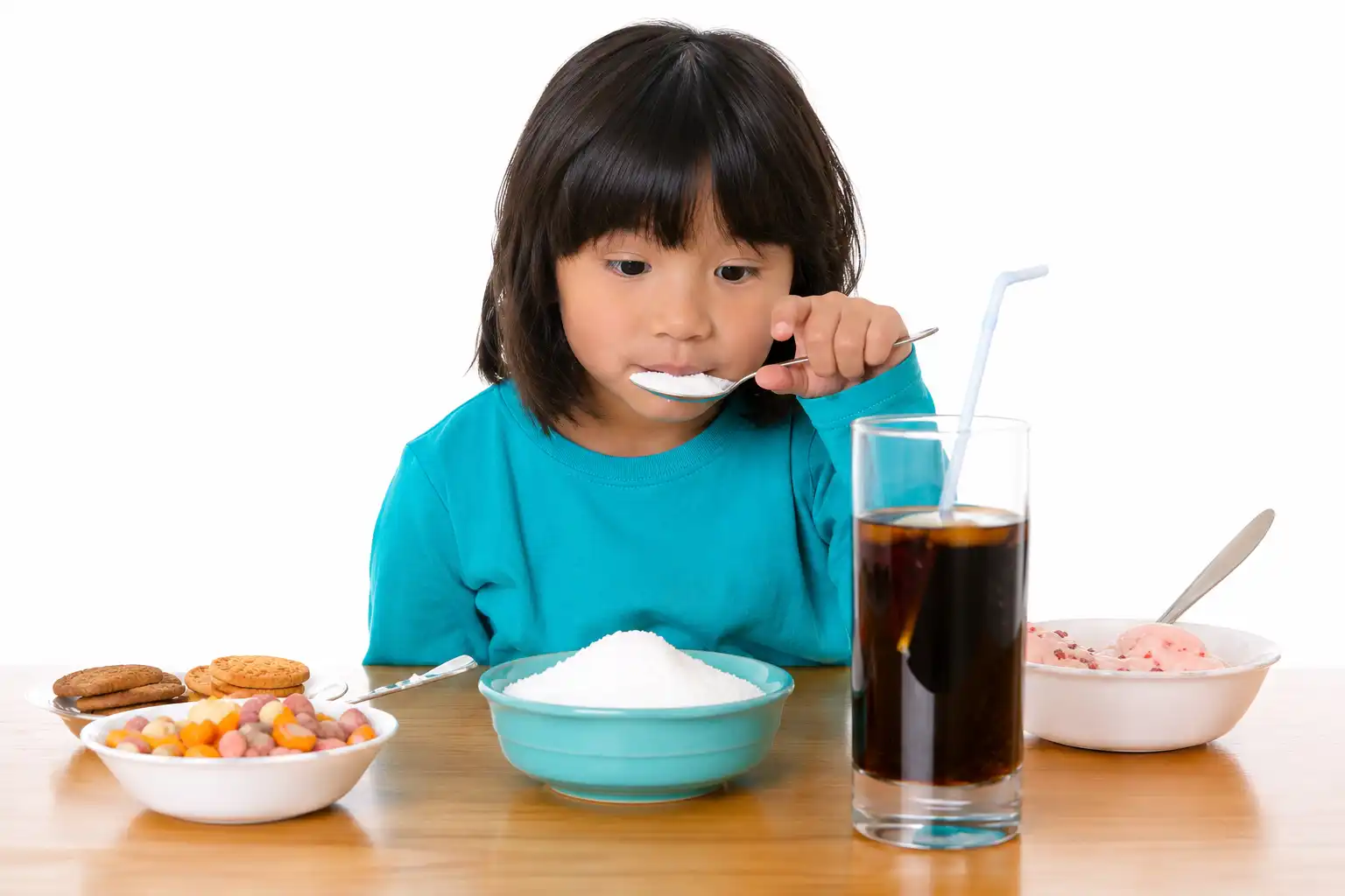 Child consuming sugary foods that increase the risk of tooth decay and poor oral hygiene.